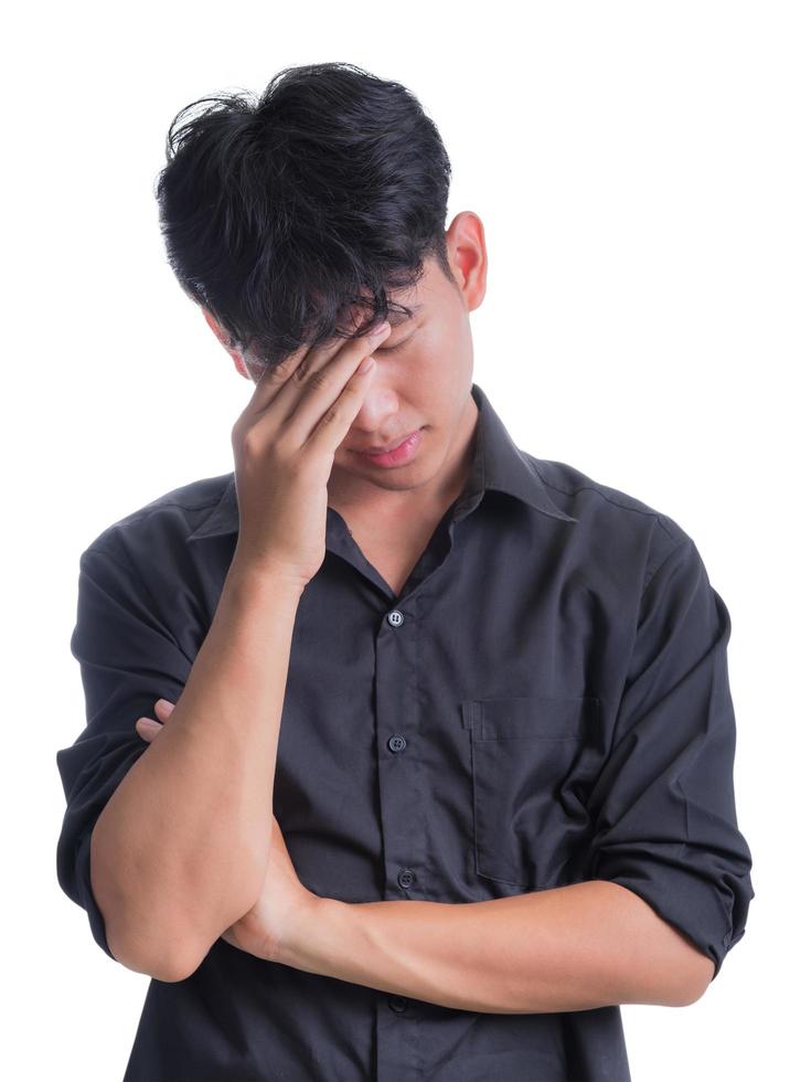 A young man in a long black shirt is worried about something. photo