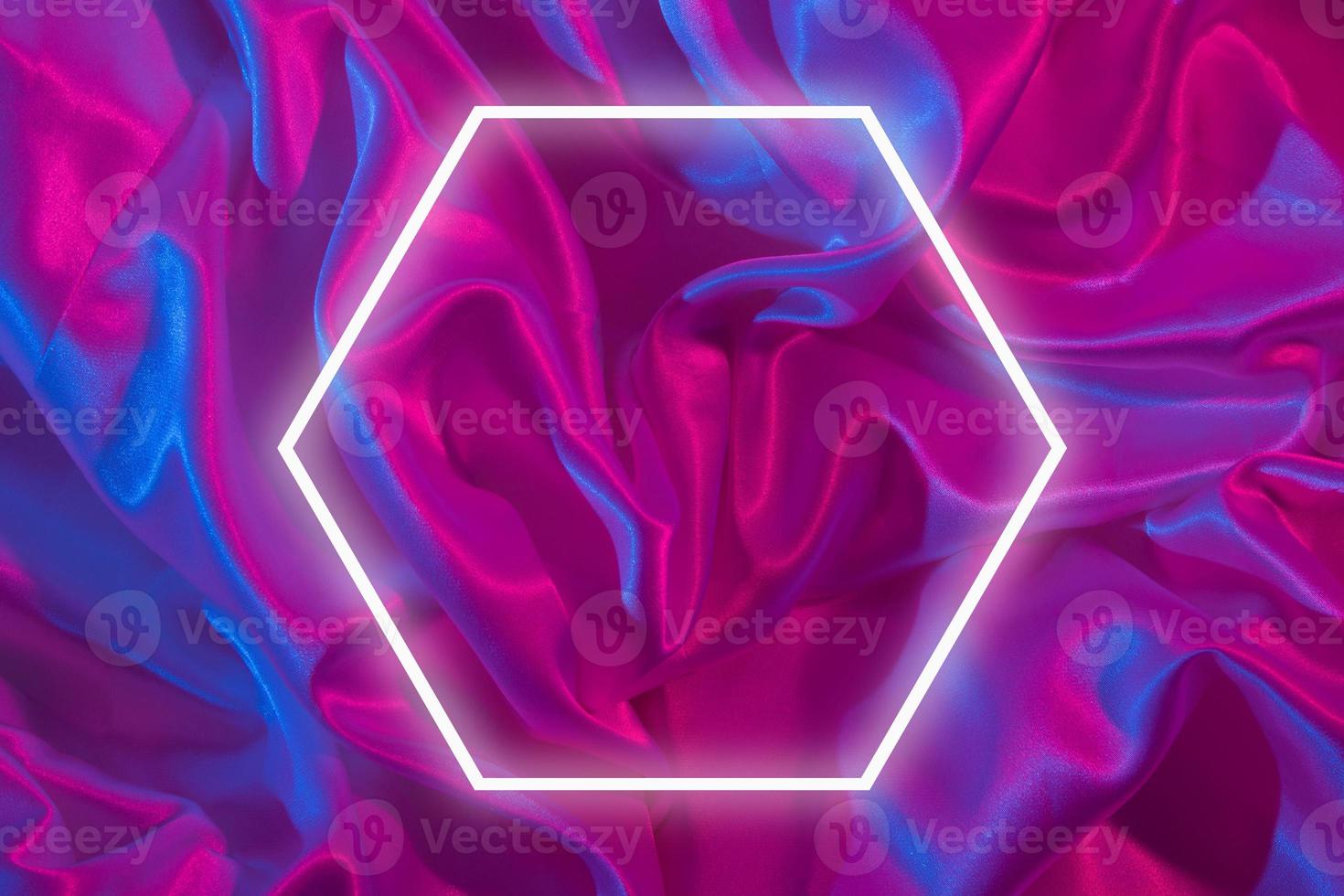 Light frame on pleated santine fabric in neon light. Creative abstract background for yor text photo