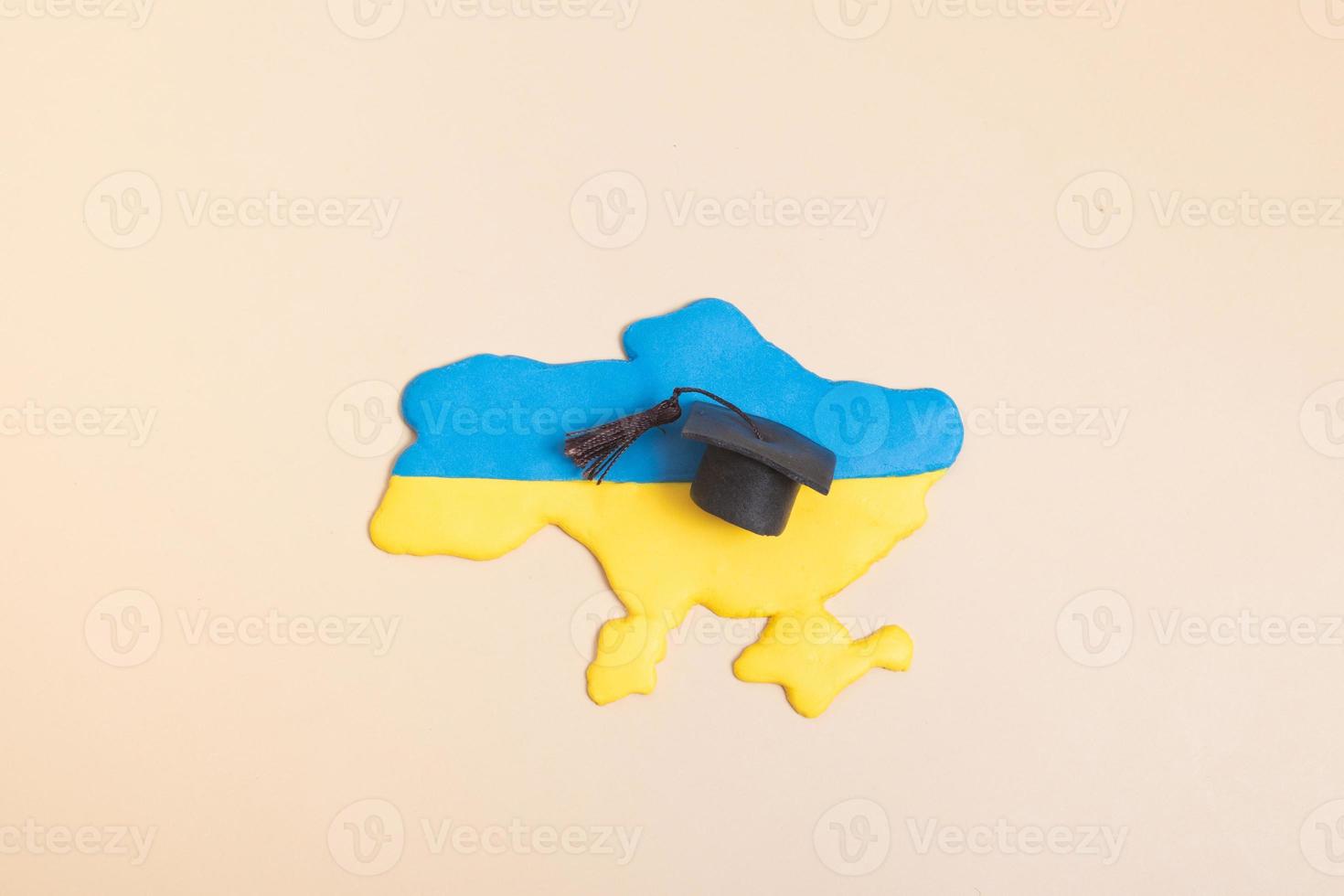 Plasticine map of Ukraine with a graduate hat. Education in Ukraine concept photo