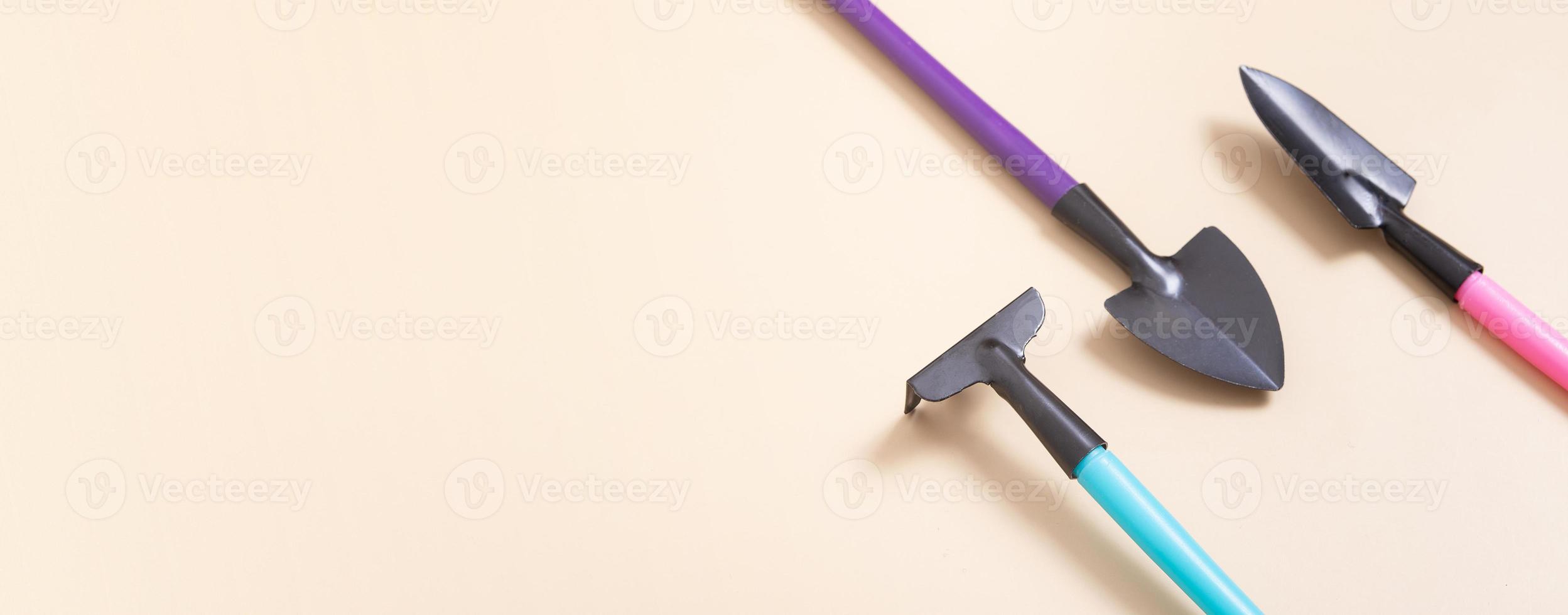 Banner with rakes and shovels for gardening. Minimal flat lay. The concept of spring planting photo