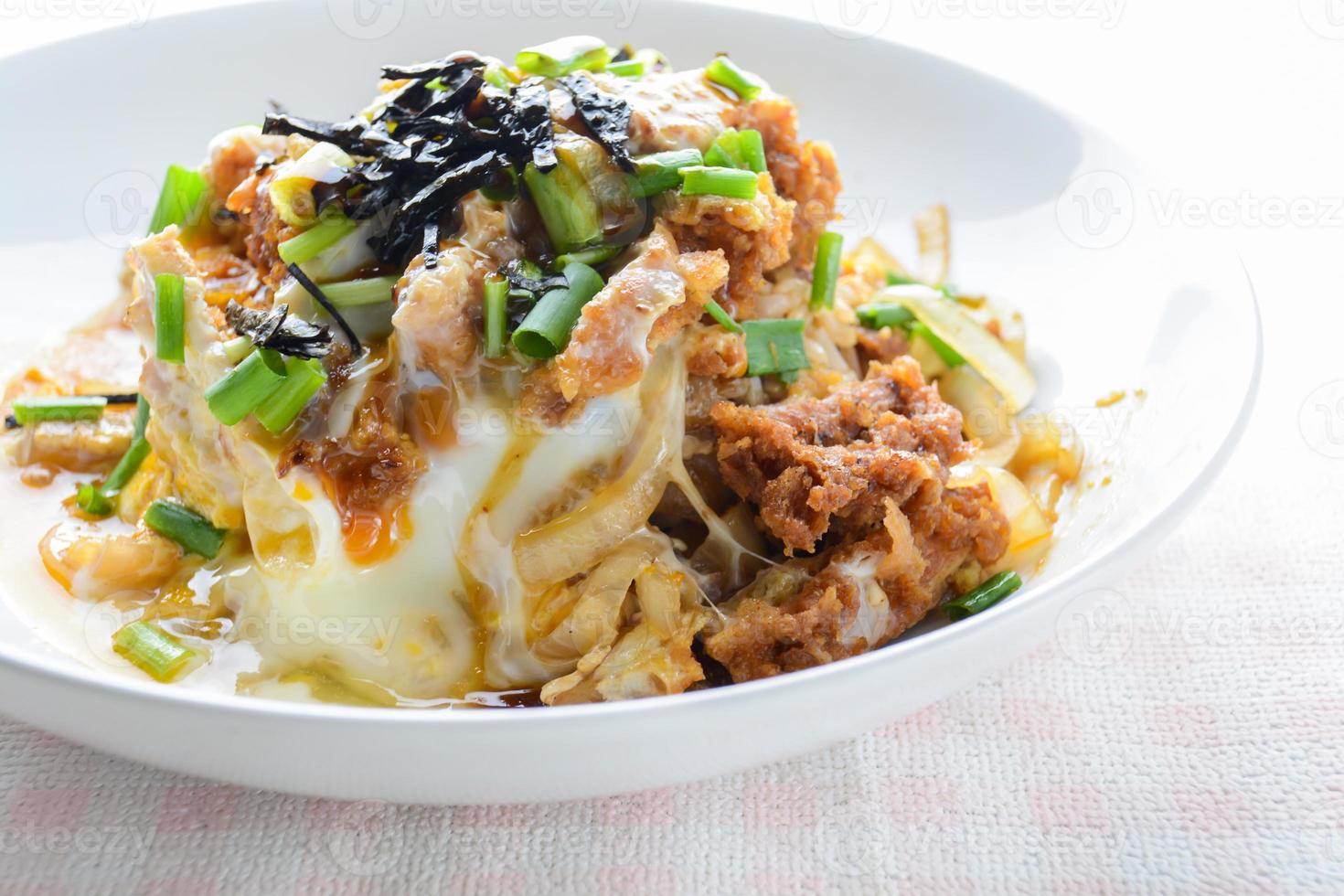 Japanese traditional food, Tonkatsu deep-fried pork cutlet on top with eggs photo