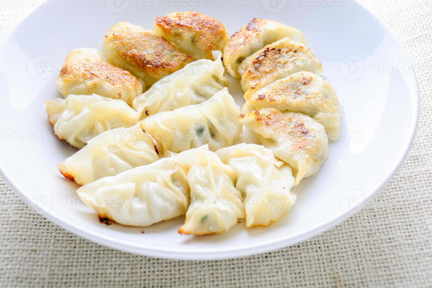 Japanese Fried Dumplings, the half moon-shaped dumplings served in Asian restaurants as an appetiser or side dish, pork and vegetable filling. photo
