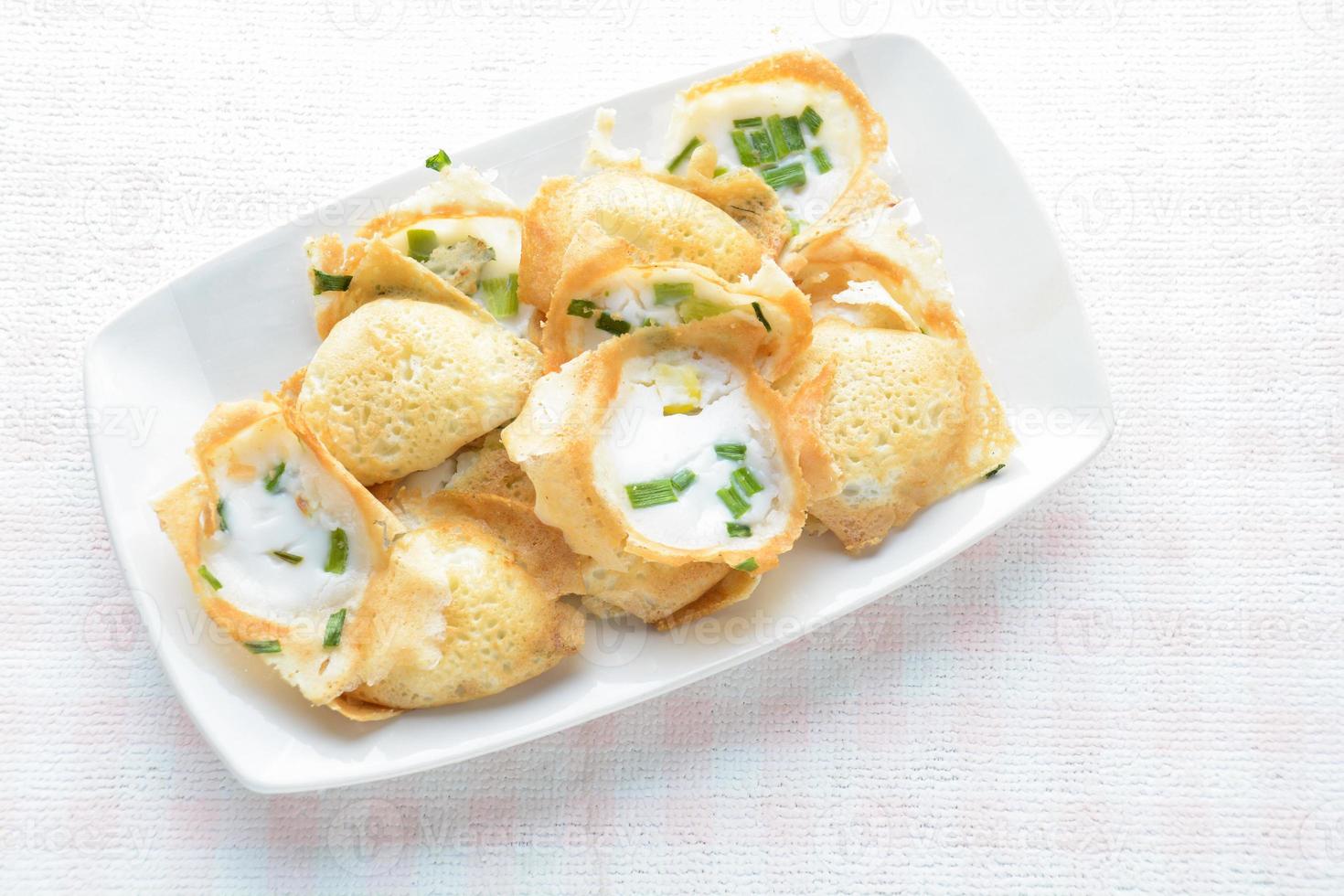Khanom khrok or coconut-rice pancakes are one of the ancient Thai desserts. They are prepared by mixing rice flour, sugar, and coconut milk to form a dough. photo