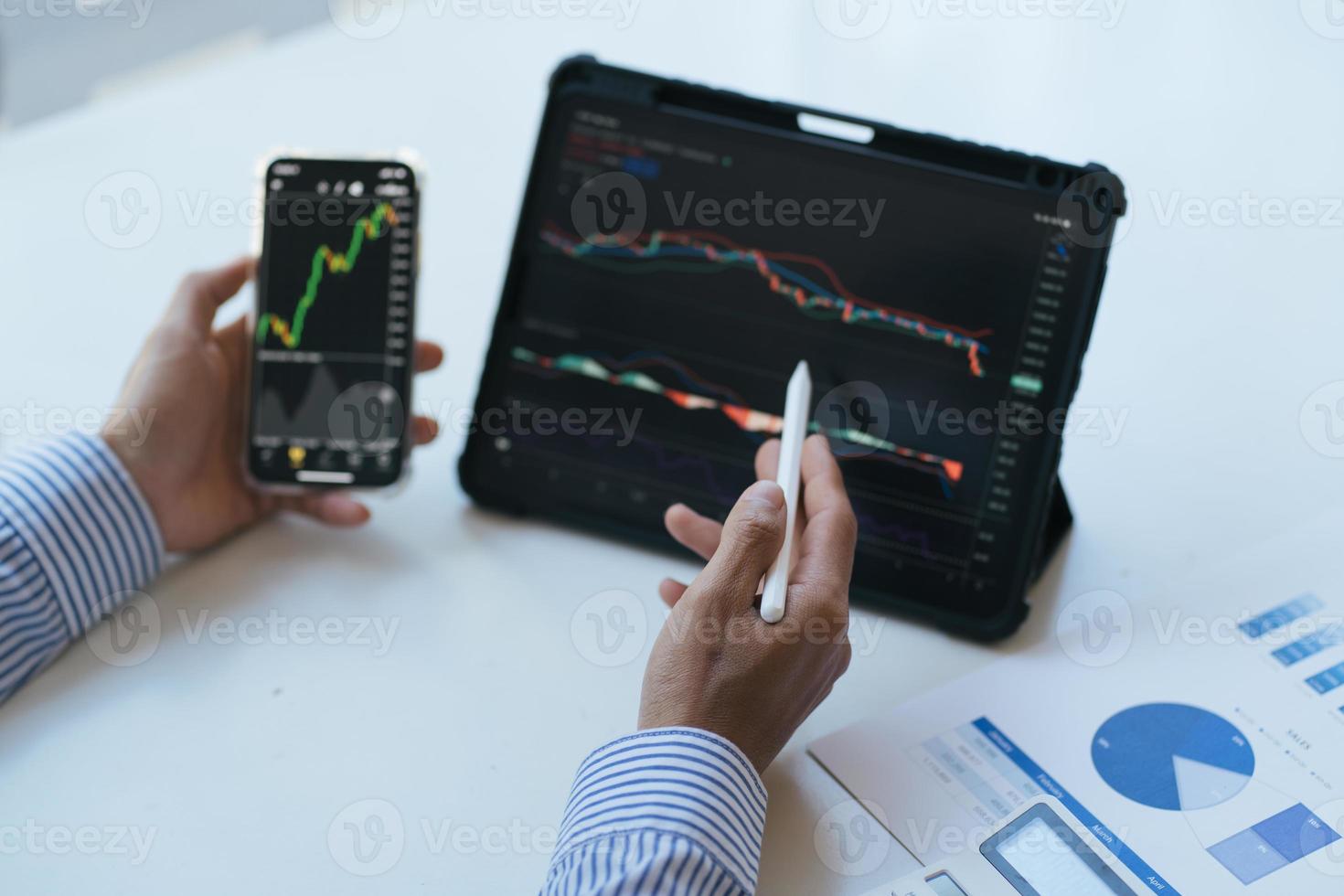 Stock exchange market concept, Business investor trading or stock brokers having a planning and analyzing with display screen and pointing on the data presented and deal on a stock exchange. photo