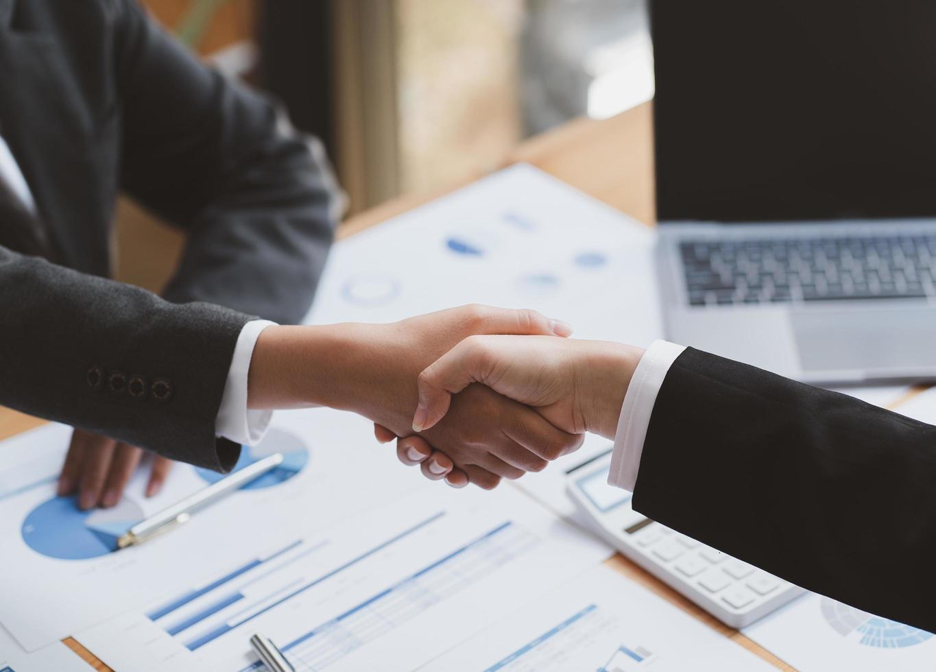 businesswomen Handshaking,happy with work,the woman she is enjoying with her workmate,Handshake Gesturing People Connection Deal Concept photo