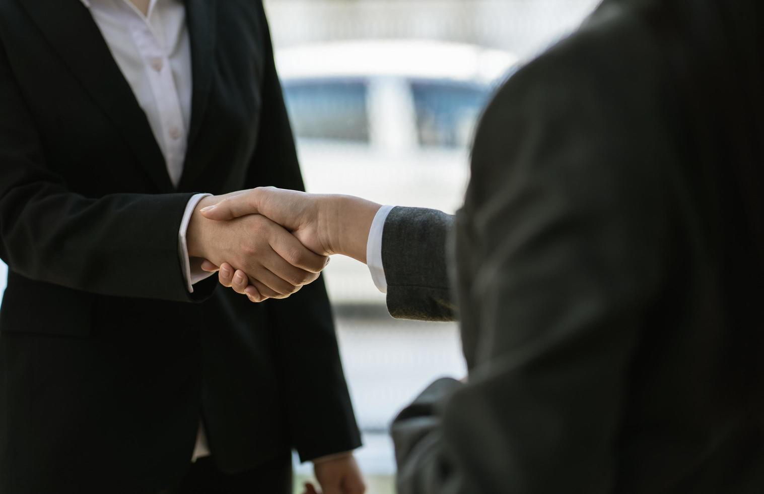 businesswomen Handshaking,happy with work,the woman she is enjoying with her workmate,Handshake Gesturing People Connection Deal Concept photo