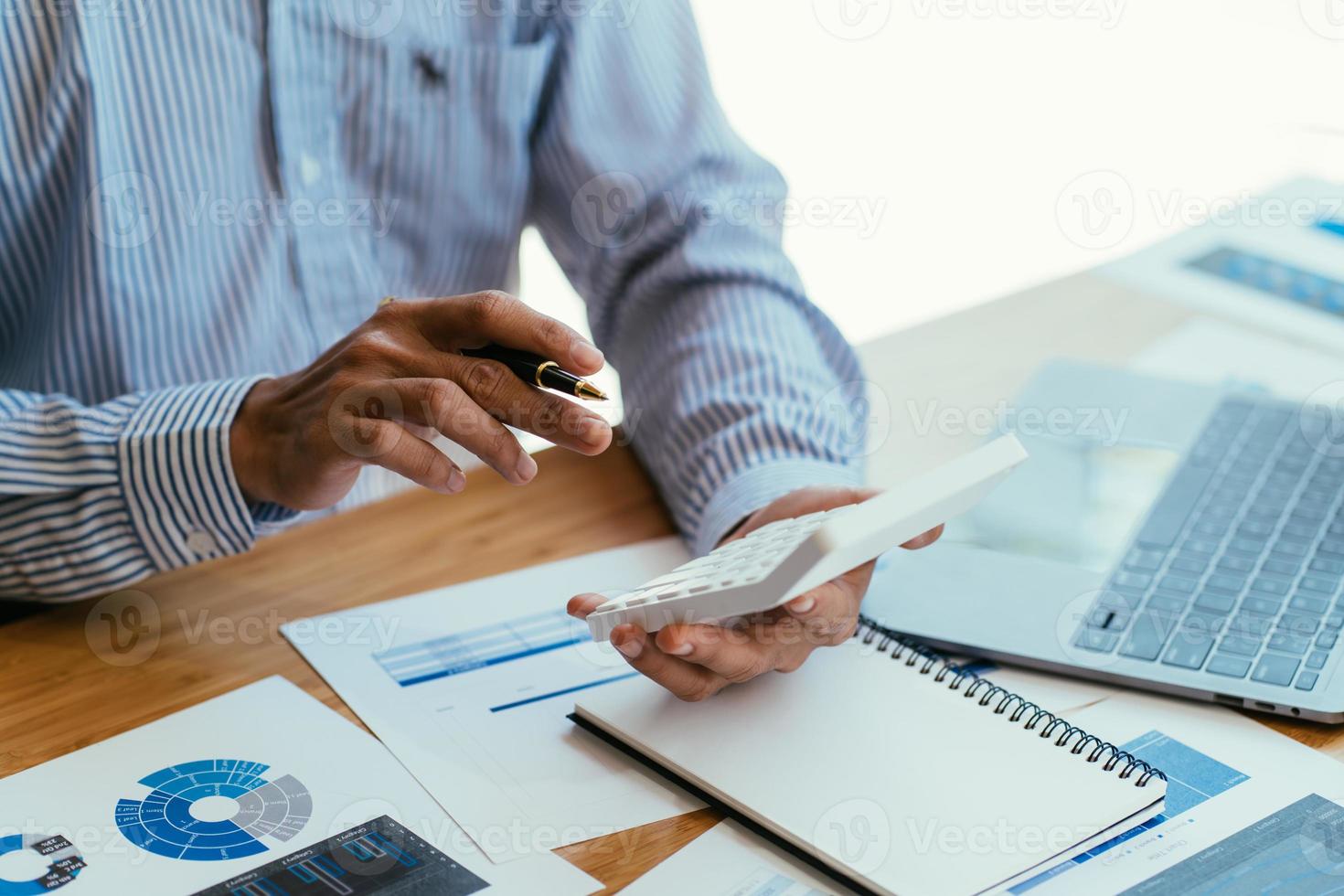 Business accounting concept, Business man using calculator with computer laptop, budget and loan paper in office. photo