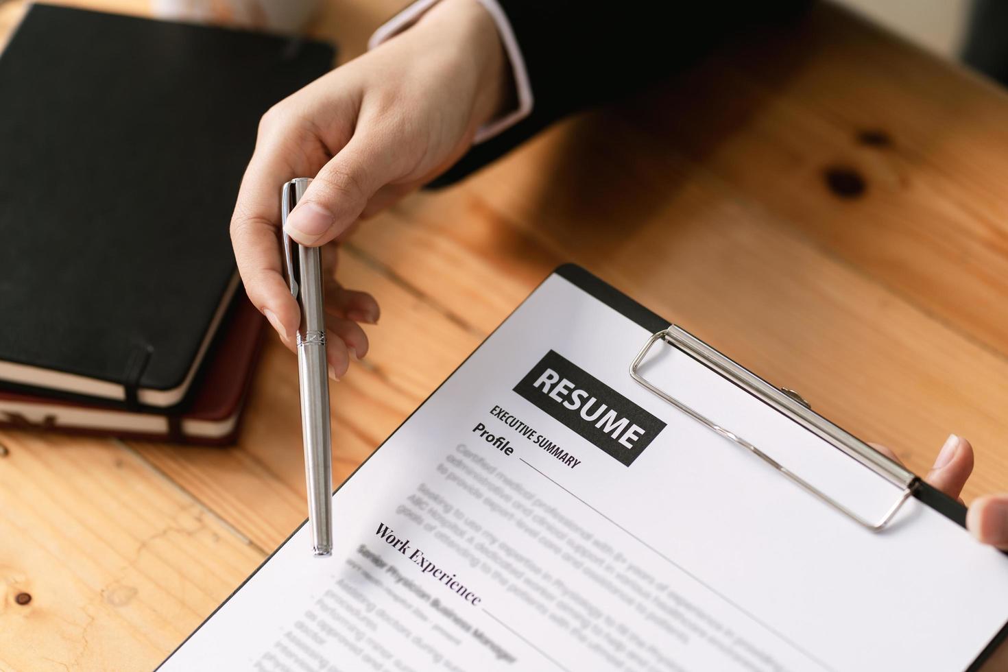 woman submit resume to employer to review job application. The concept presents the ability for the company to agree with the position of the job. photo