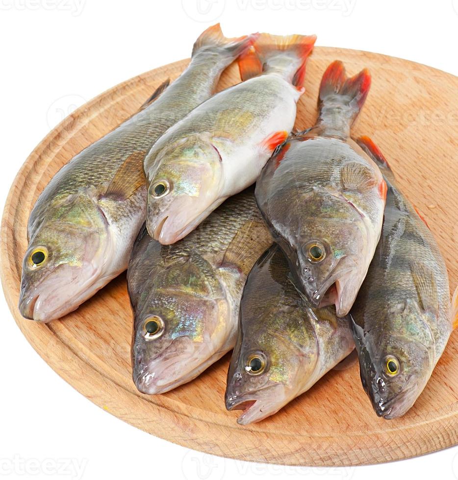 Raw fish on a cutting board isolated on white background photo