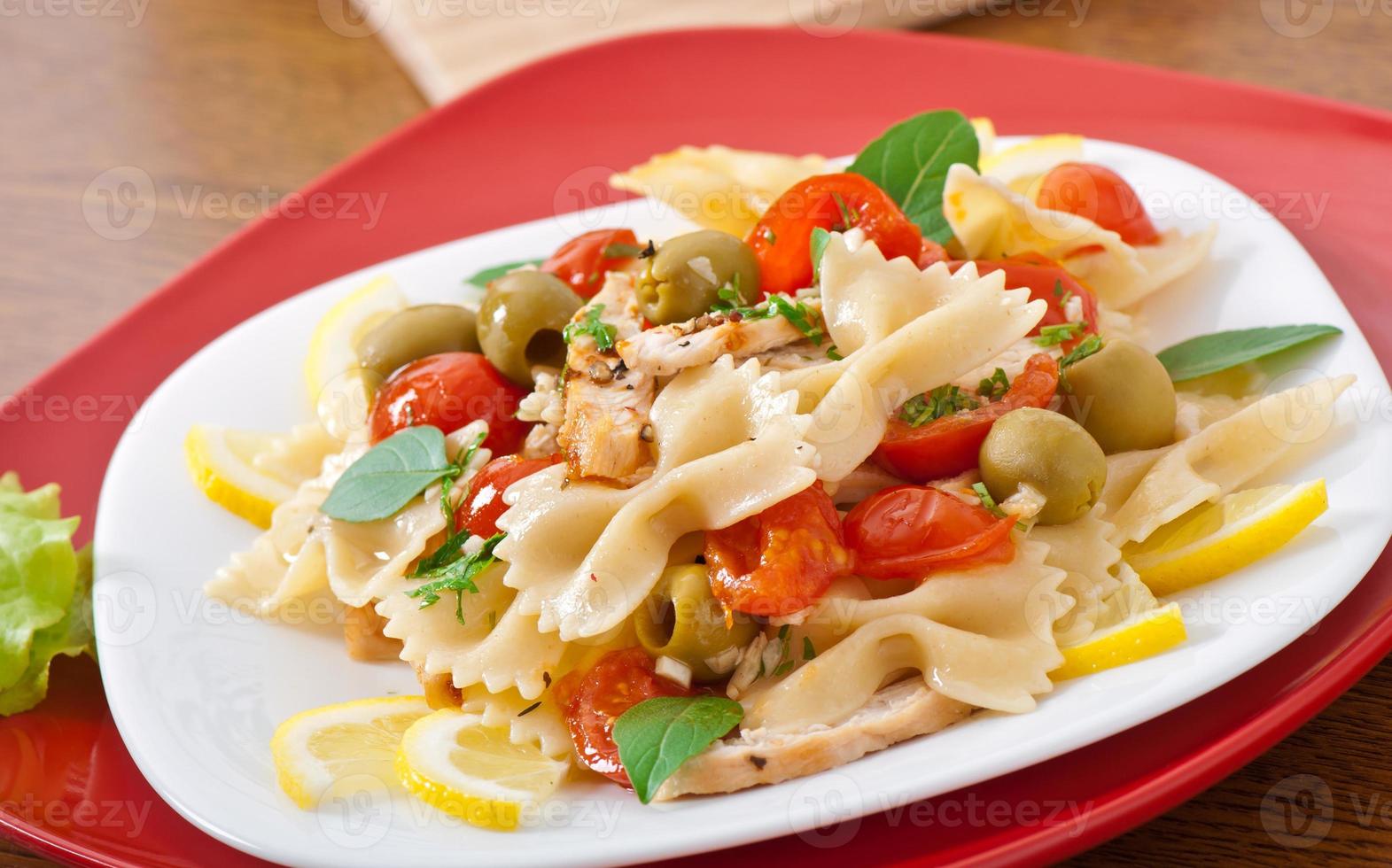 Spanish salad with pasta bows, tomatoes and chicken photo