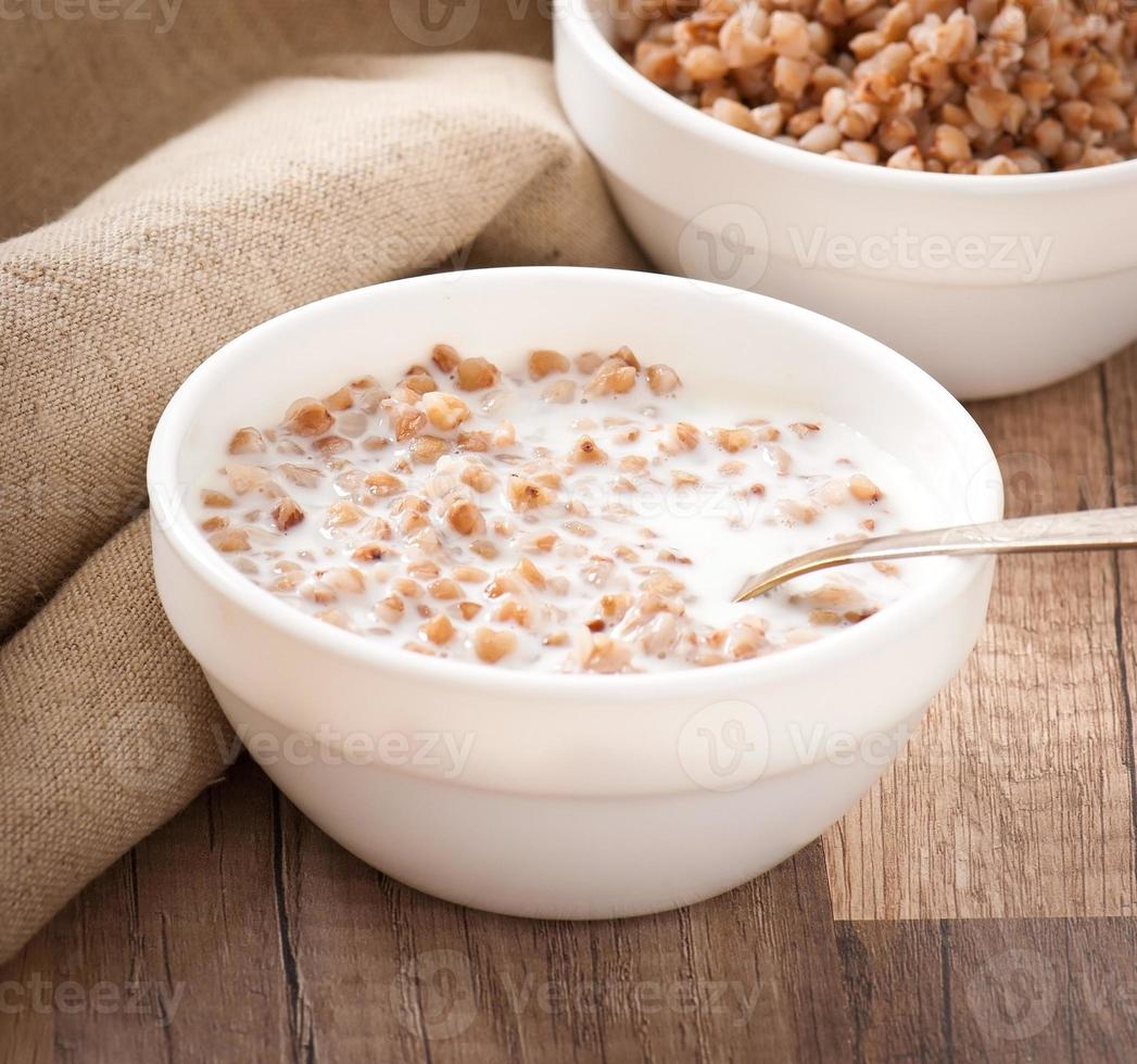 Buckwheat porridge in a bowl on a wooden table photo