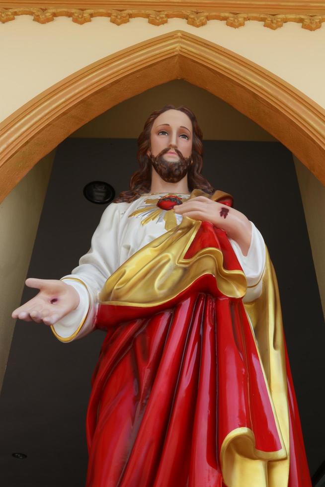 Jesus statue is in arch and standing posture. photo