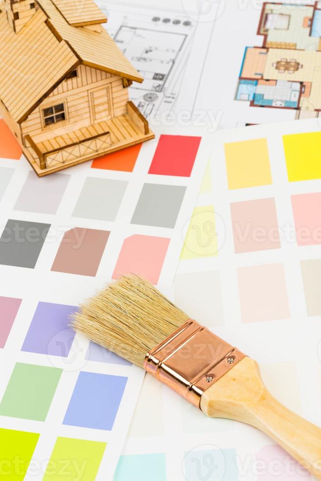 Paint color sample catalog with brush, drawing, and house model photo