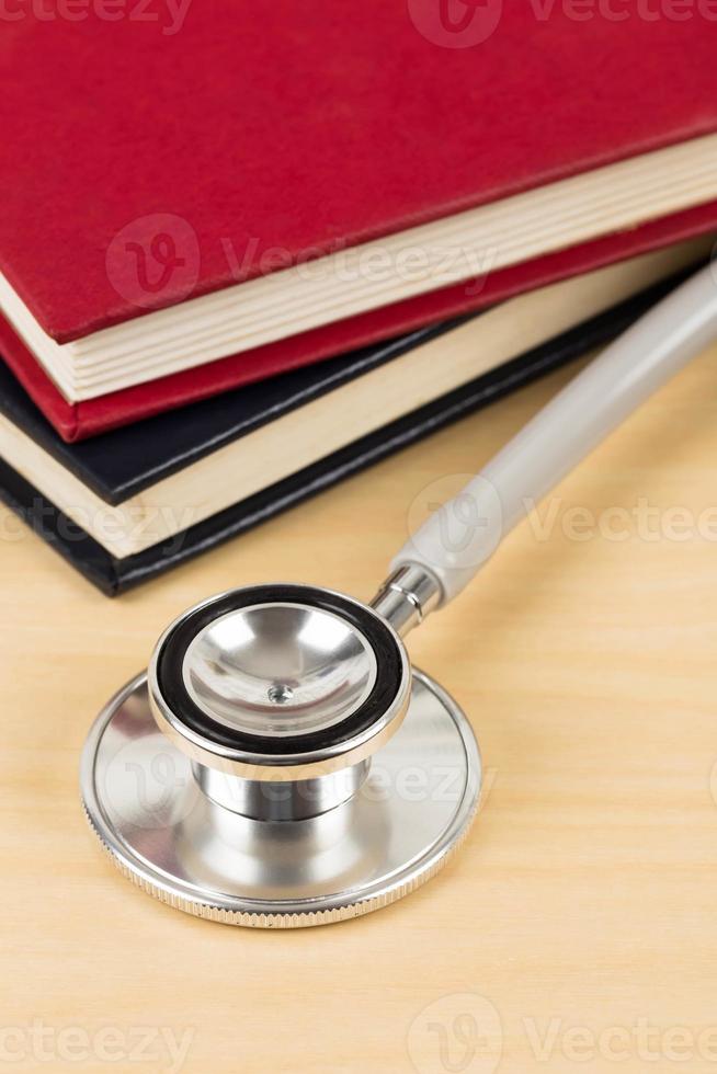 Stethoscope and textbook concept for medical education photo