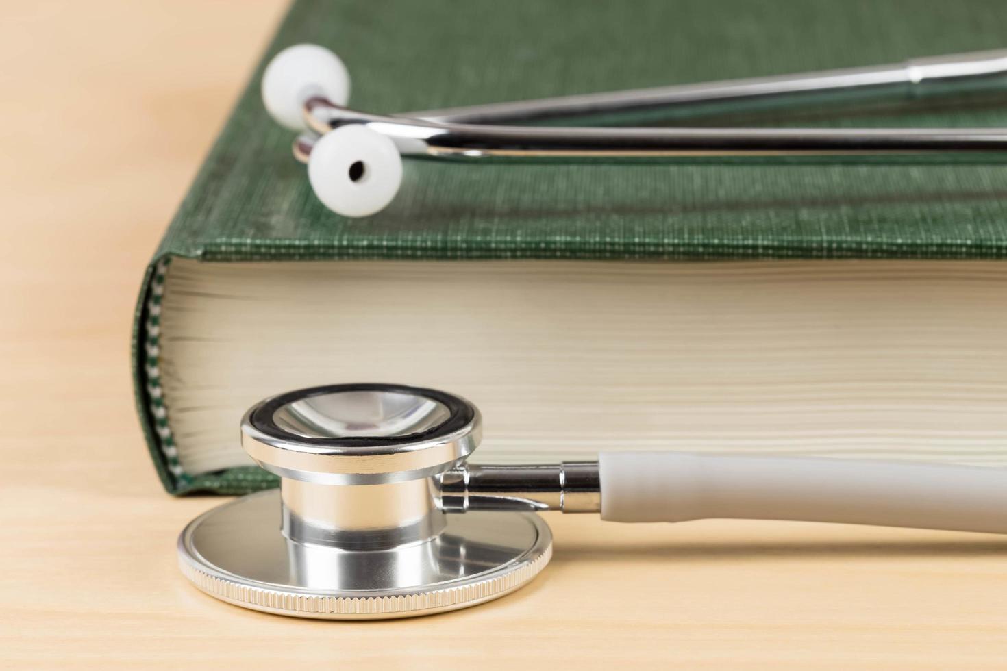 Stethoscope and textbook concept for medical education photo