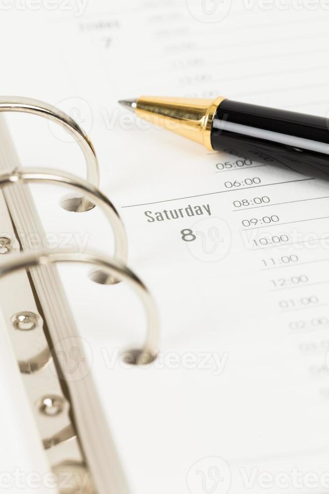 Calendar page organizer notebook weekend Saturday with pen photo