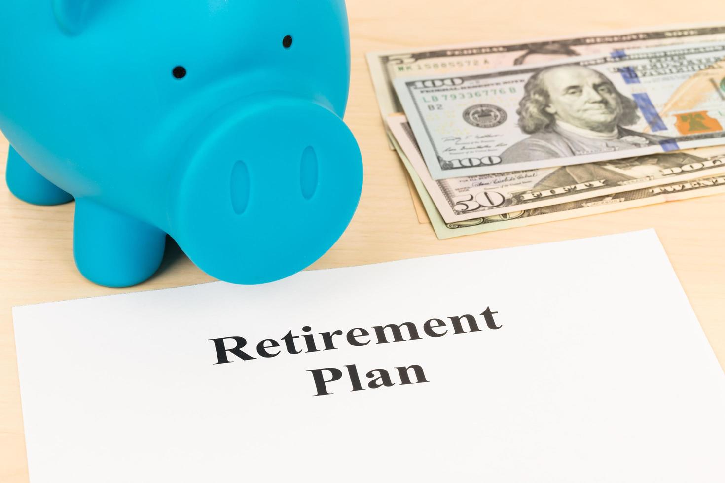 Retirement plan with banknote, piggy bank, and pen photo