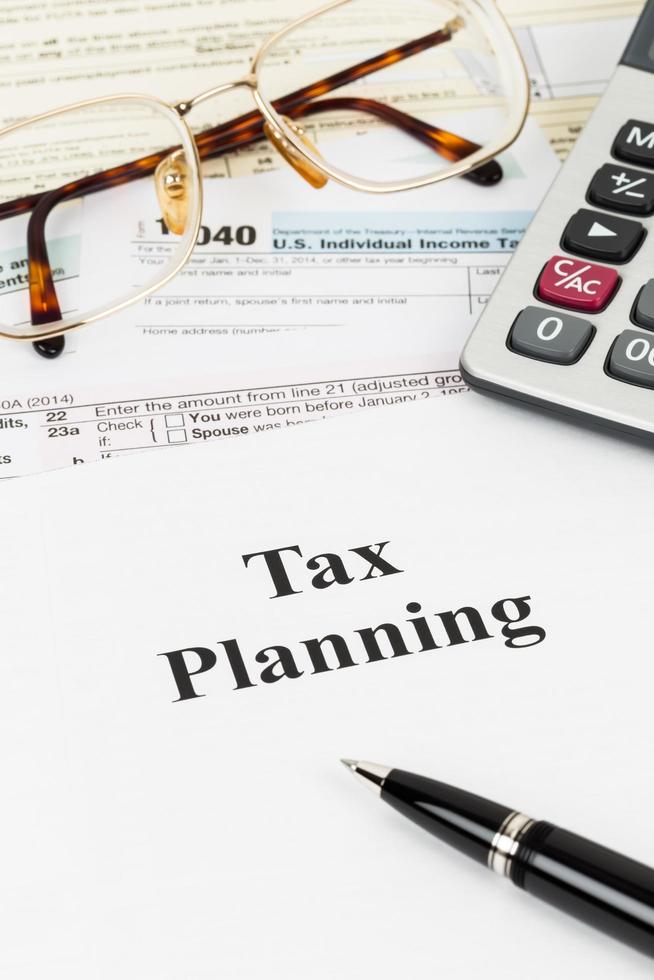 Tax planning wirh calculator and glasses taxation concept photo