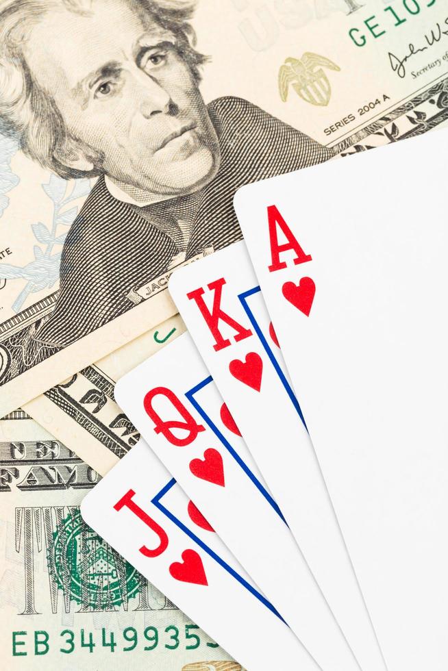 Royal flush poker playing cards on dollar banknote photo