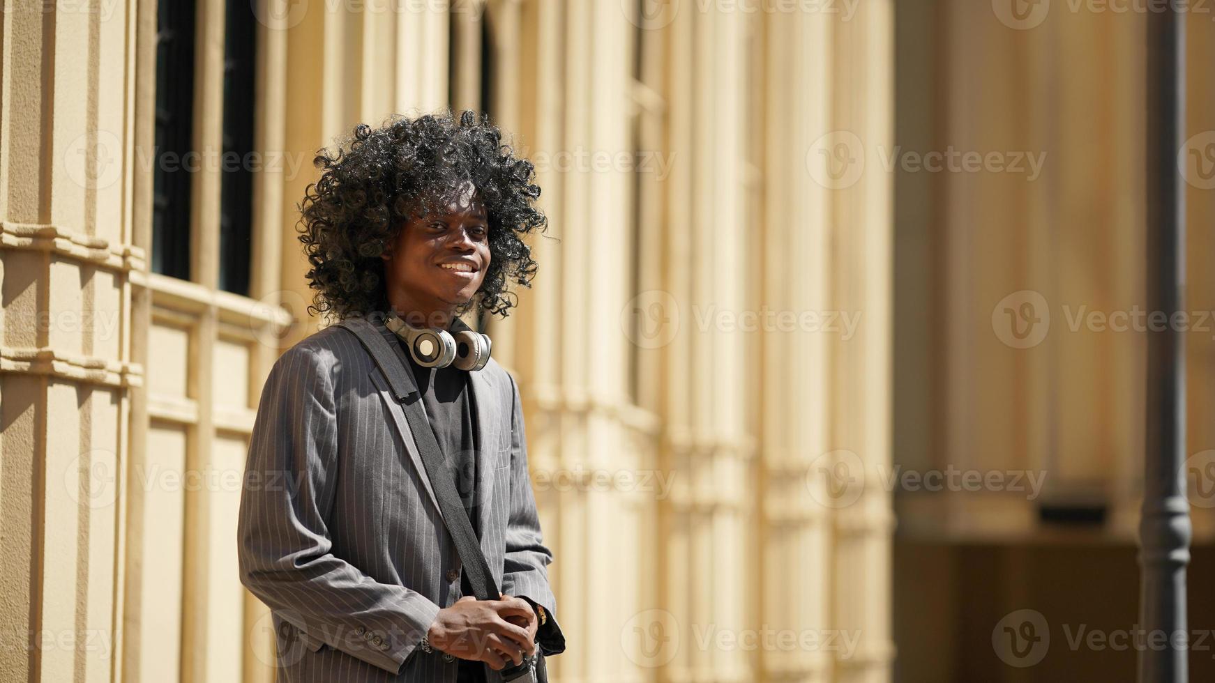 Afro American man having fun walking in city center - Happy young guy enjoying time a sunset outdoor - Millennial generation lifestyle and positive people attitude concept photo