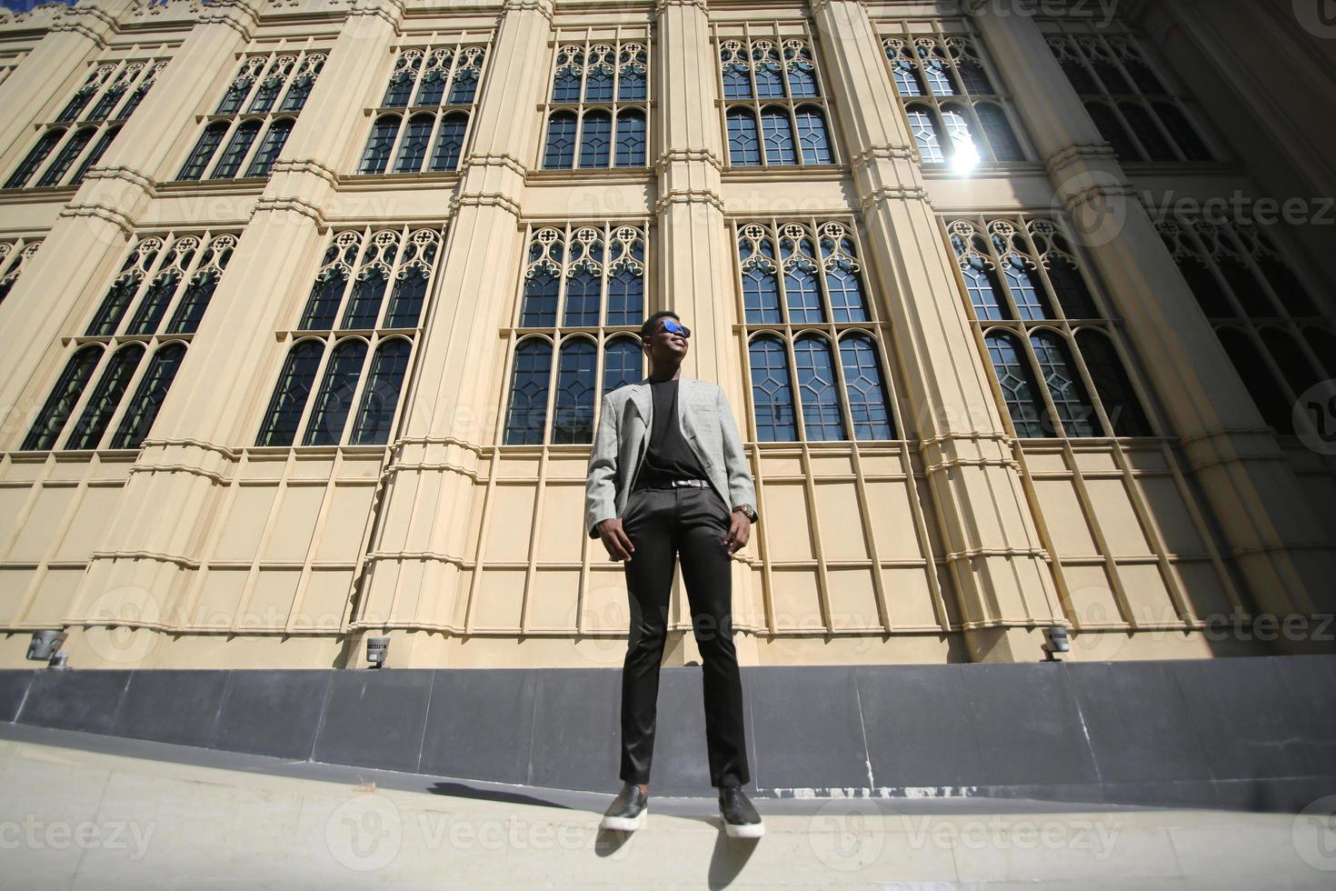 Afro American man having fun walking in city center - Happy young guy enjoying time a sunset outdoor - Millennial generation lifestyle and positive people attitude concept photo