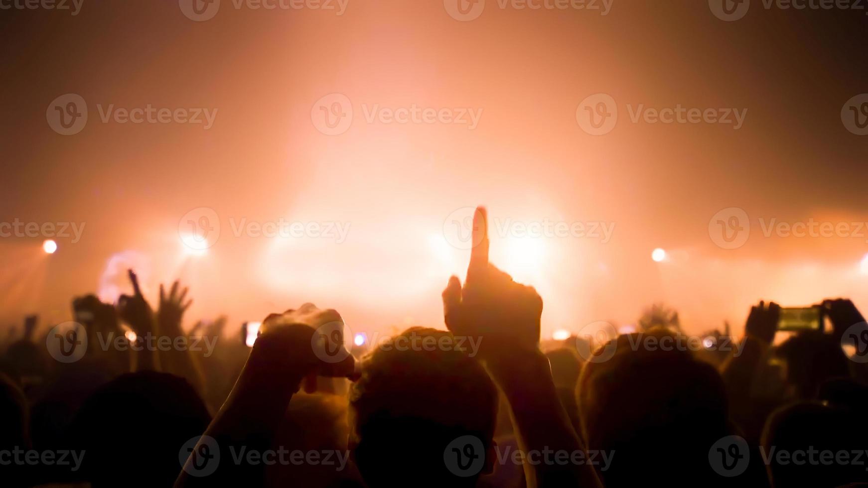 Party People Rock Concert. Crowd Happy and Joyful and Applauding or Clapping. Celebration party festival happiness. Blurry night club. Concert Show with DJ Music festival EDM on Stage photo