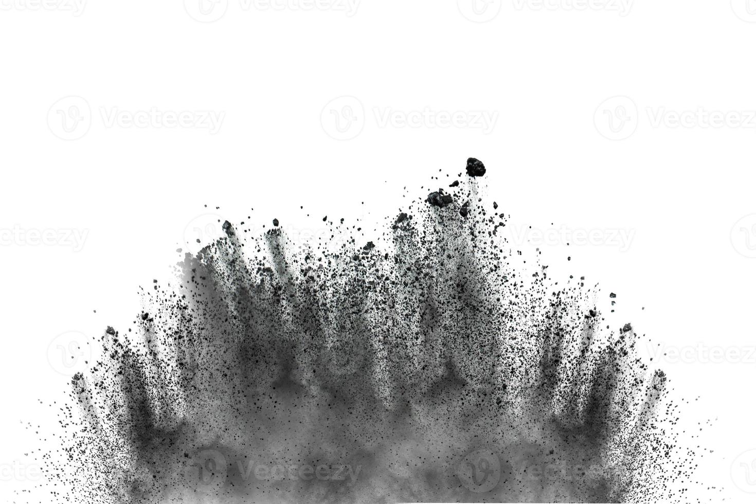 Black particles splattered on white background. Black powder dust splashing. photo