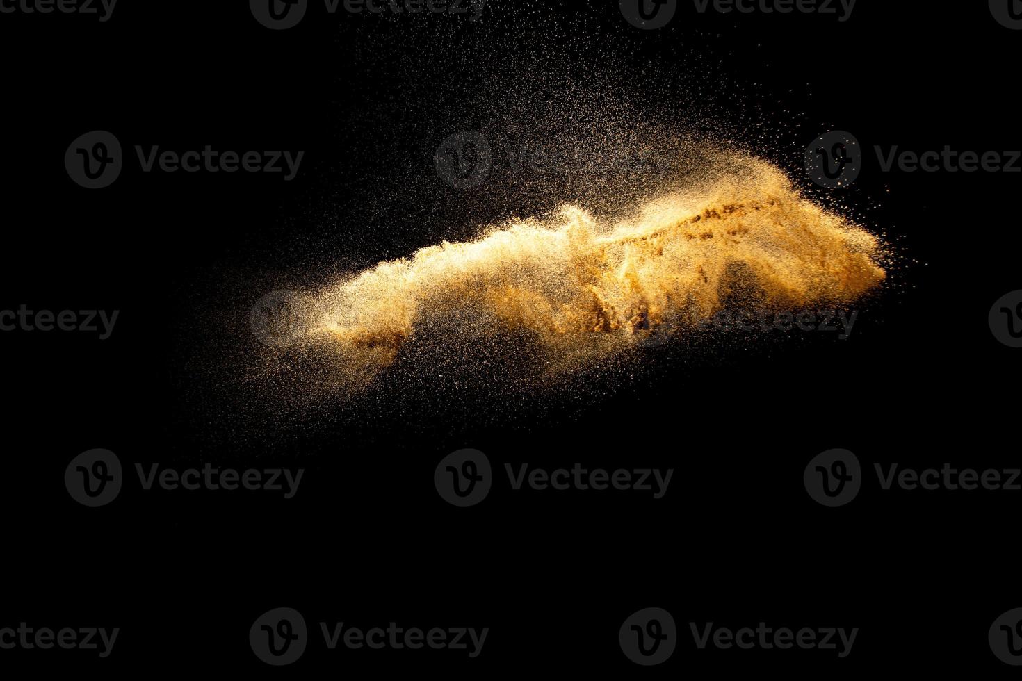 Abstract motion blurred brown sand background.Sandy explosion isolated on over dark background. photo