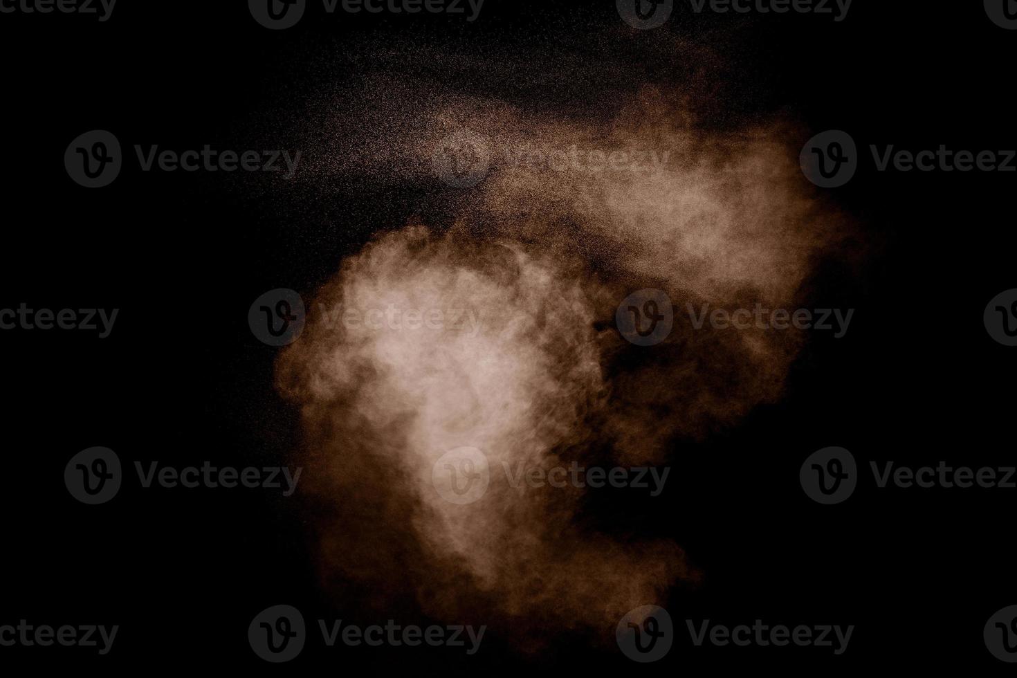 Freeze motion of brown dust explosion. Stopping the movement of brown powder. photo