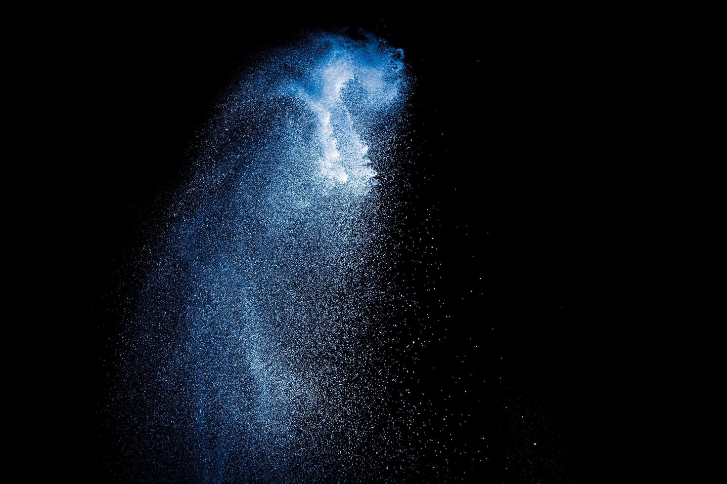 Blue color powder explosion on white background. photo