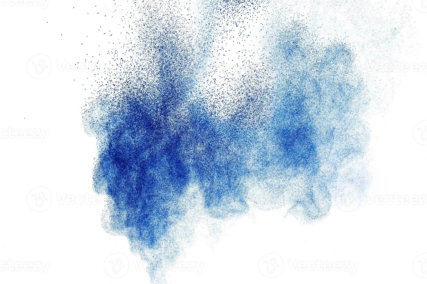 Blue color powder explosion on white background. photo