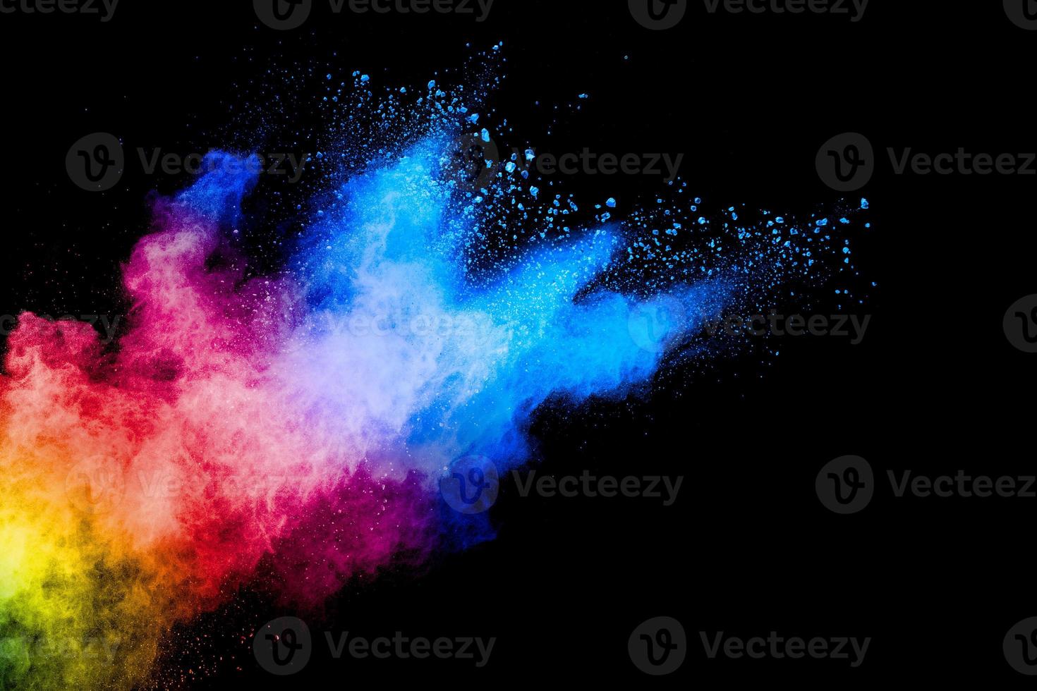 Colorful powder explosion on black background. Abstract pastel color dust particles splash. photo