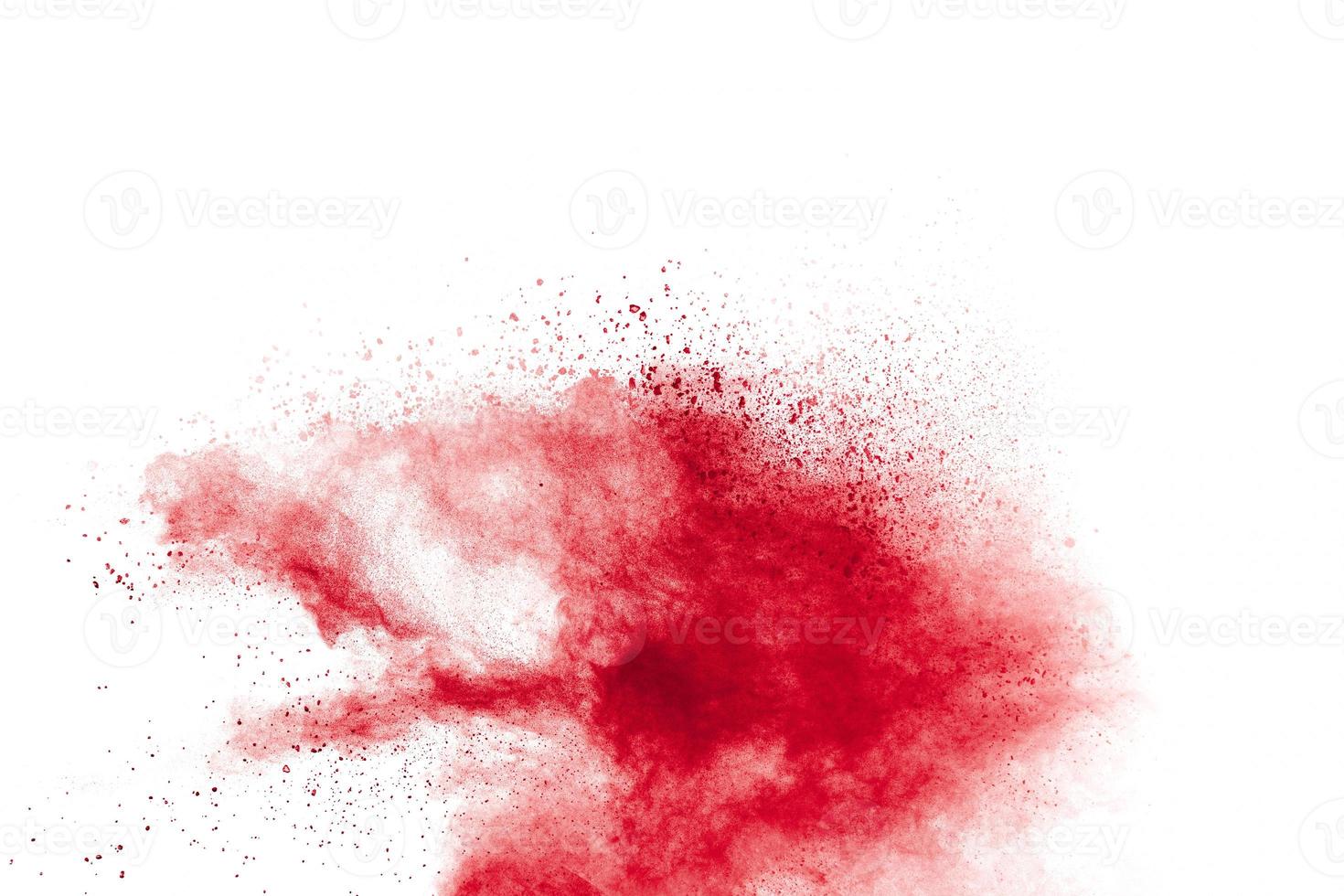 Red powder explosion on white background. Freeze motion of red dust particles splash. photo