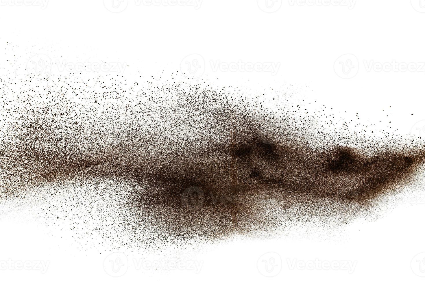 Deep Brown particles splattered on white background. Brown dust splash. photo