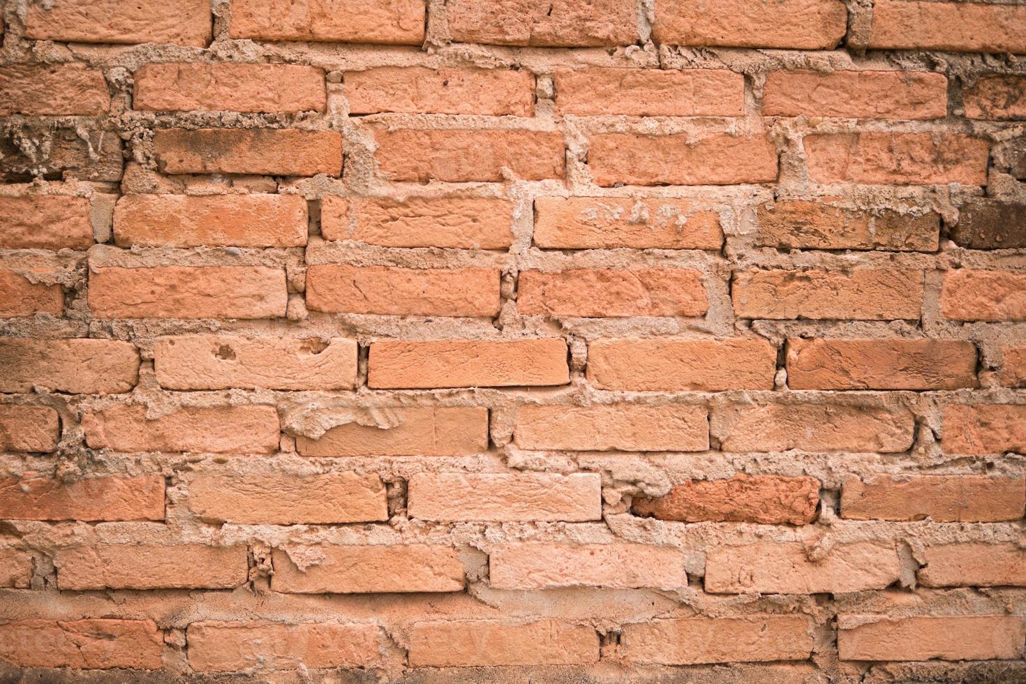 antiguo fondo texturizado de pared de ladrillo naranja. foto