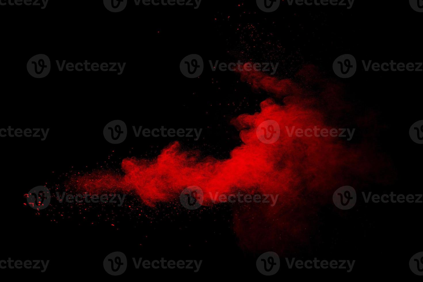 Abstract red powder on black background. Red color clouds. photo