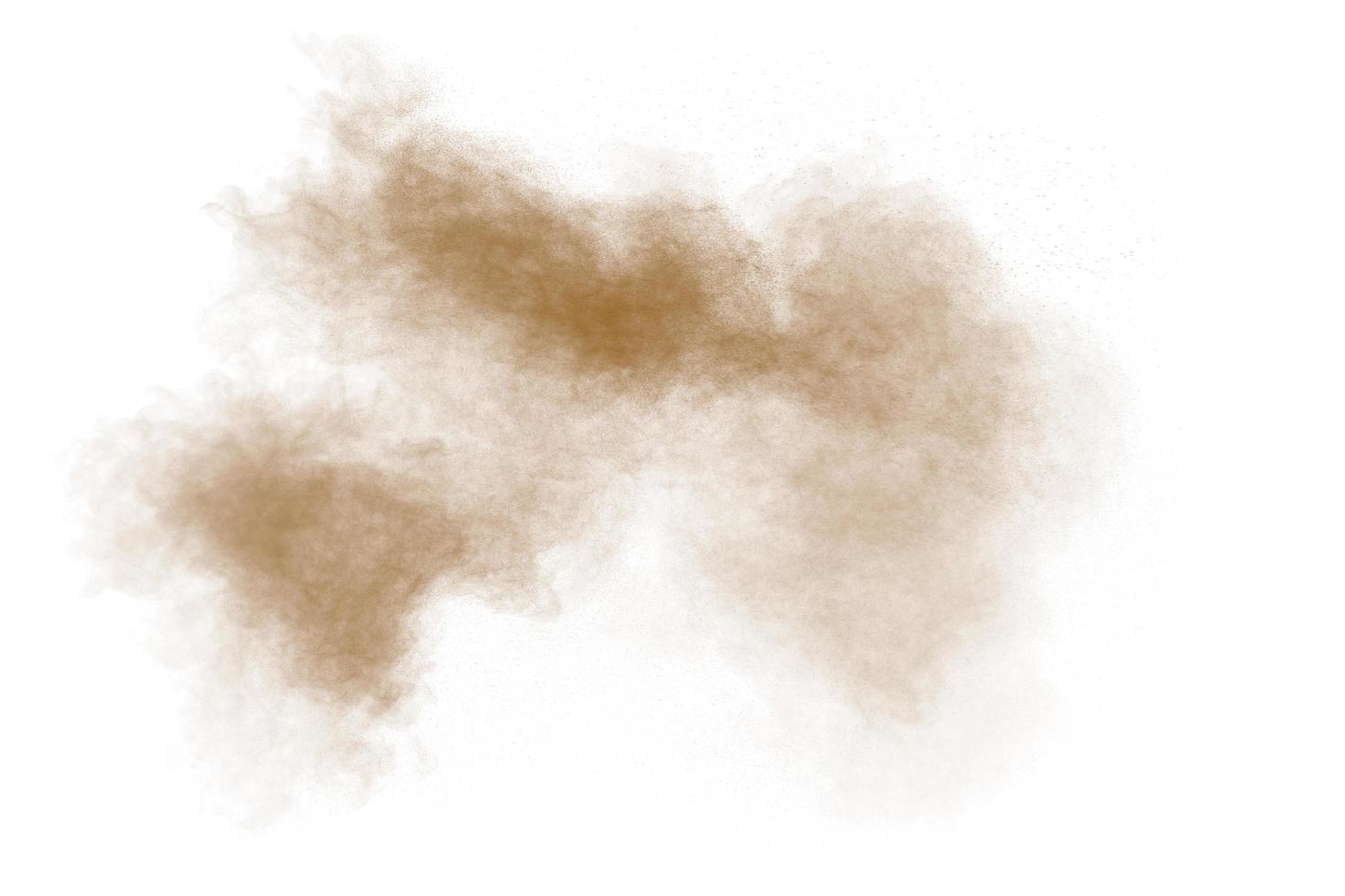 Freeze motion of brown dust explosion. Stopping the movement of brown powder. Explosive brown powder on white background. Dry soil splater on white background. photo