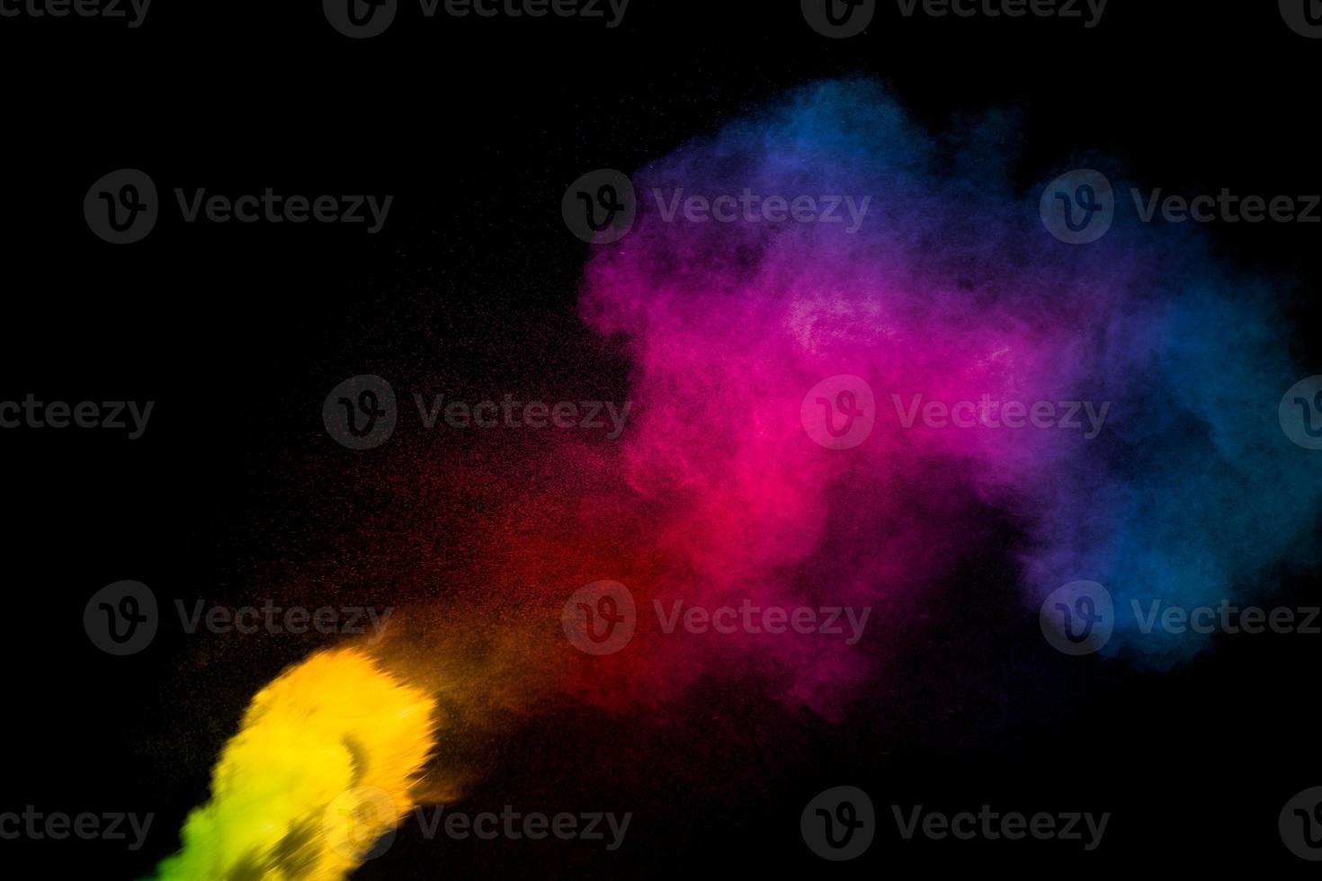 explosión de polvo multicolor abstracto sobre fondo negro. congelar el movimiento de salpicaduras de partículas de polvo de colores. Holi pintado. foto