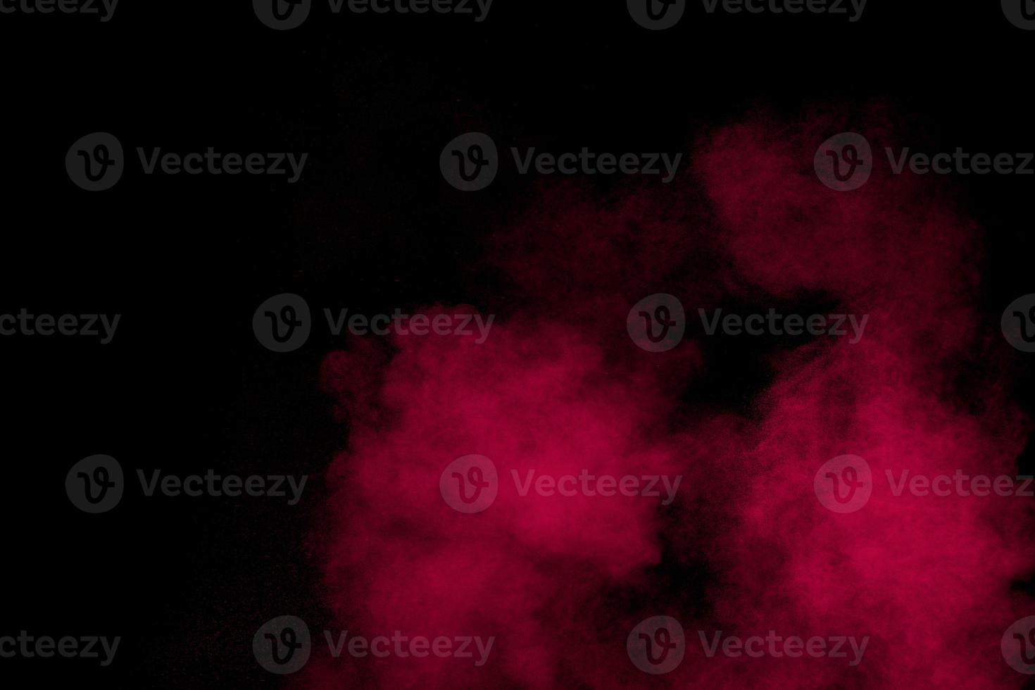 Abstract red powder dust explosion on black background. photo