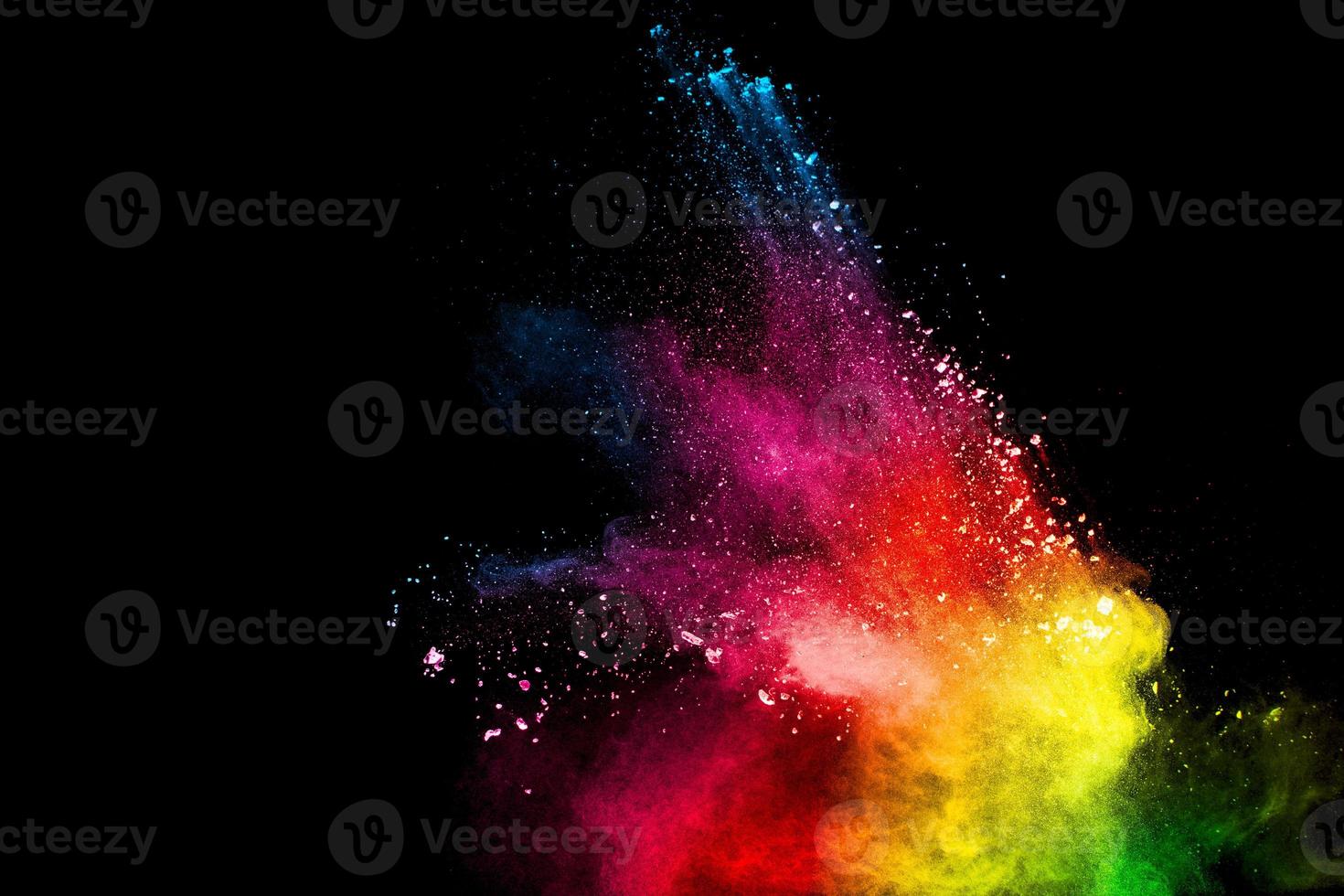 Abstract colorful powder explosion on black background.Freeze motion of dust splash.Painted Holi. photo