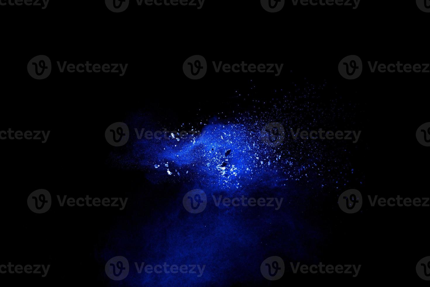 Blue powder explosion cloud on black background. photo