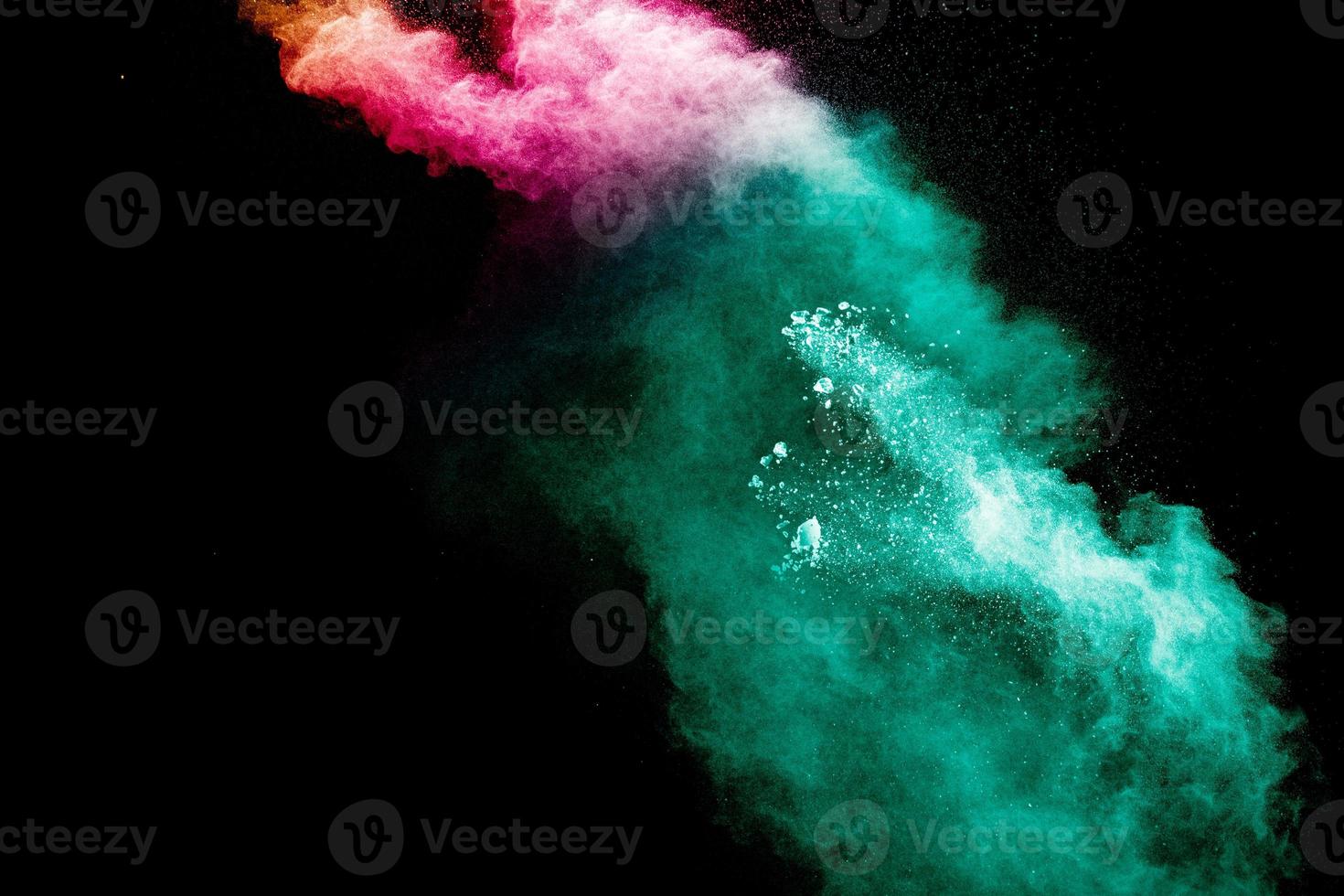 Abstract multi color powder explosion on black background. photo