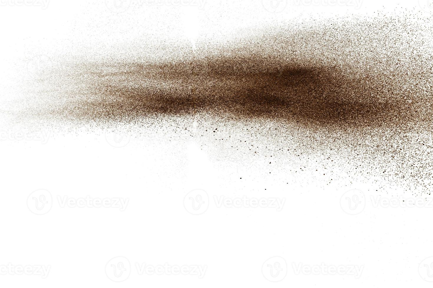 Deep Brown particles splattered on white background. Brown dust splash. photo