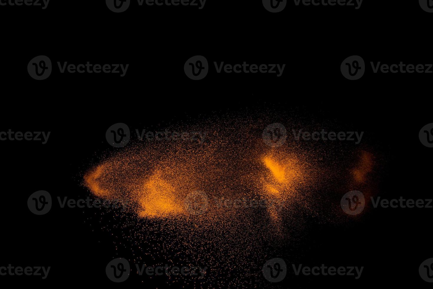 Abstract motion blurred brown sand background.Sandy explosion isolated on over dark background. photo