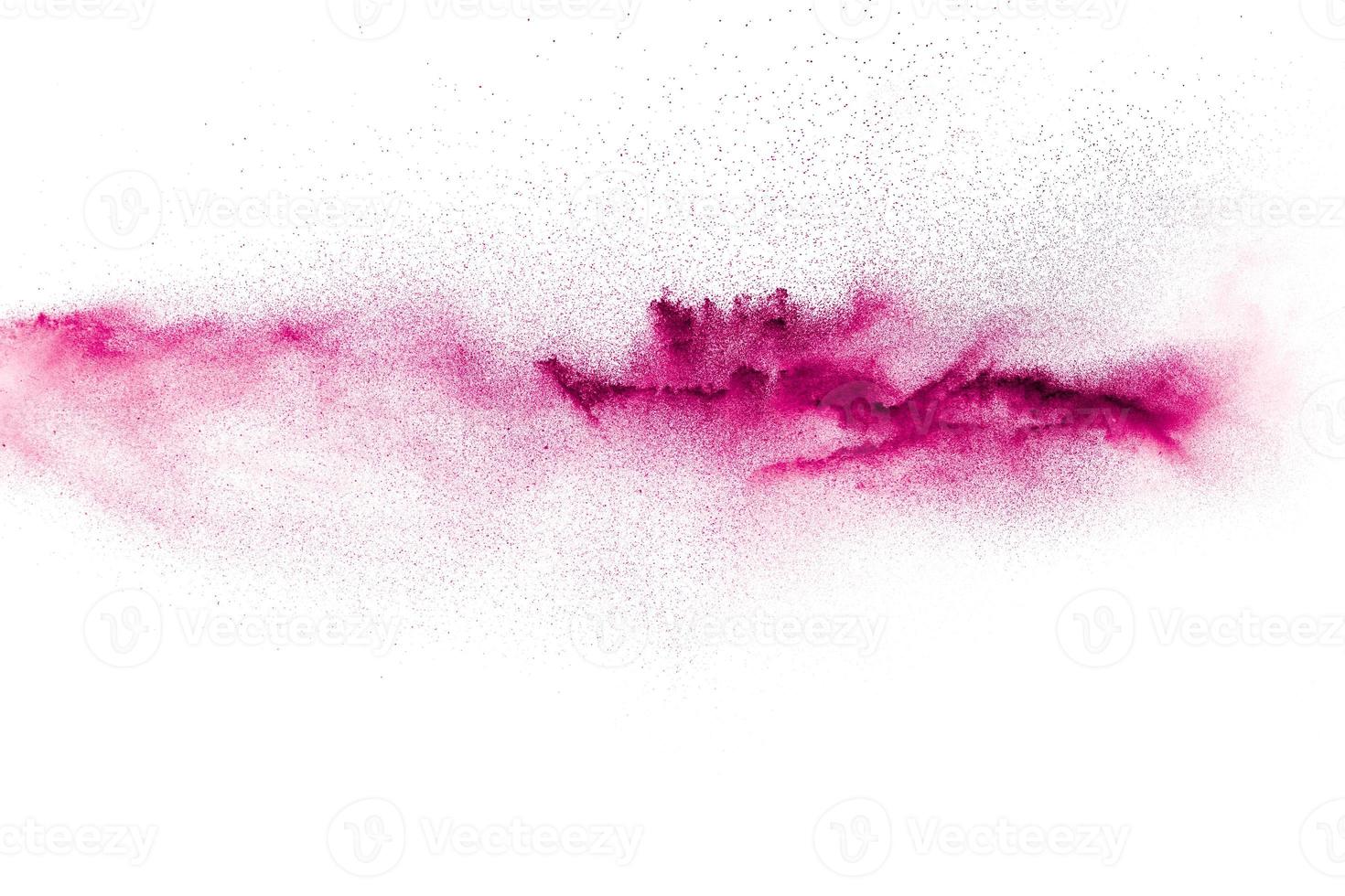 Pink particles splatter on white background. Pink powder exploding. photo