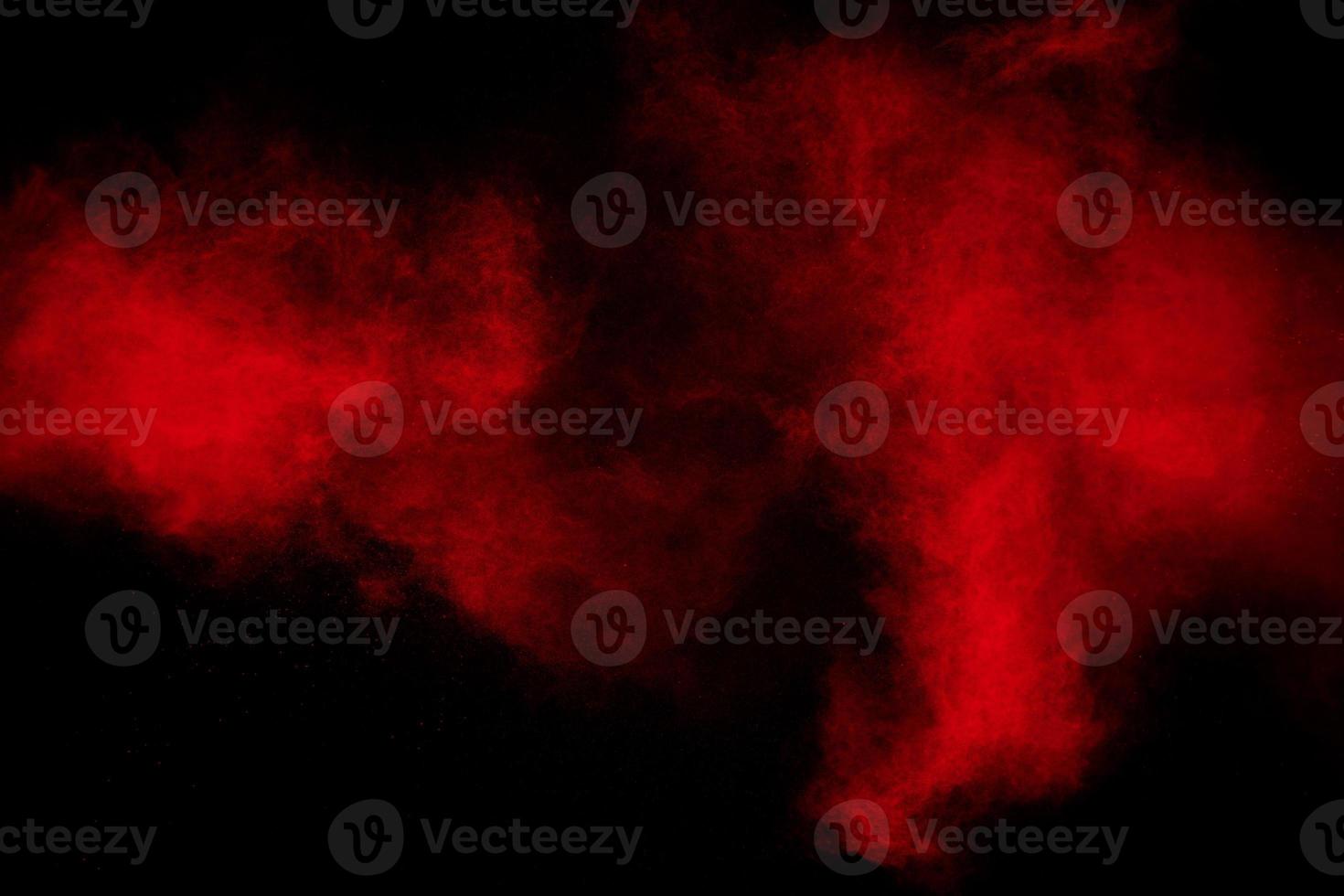 Freeze motion of red dust particles splashing. photo