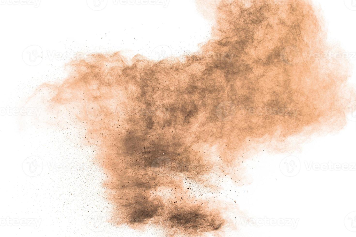 Brown powder dust cloud.Brown particles splattered on white background. photo