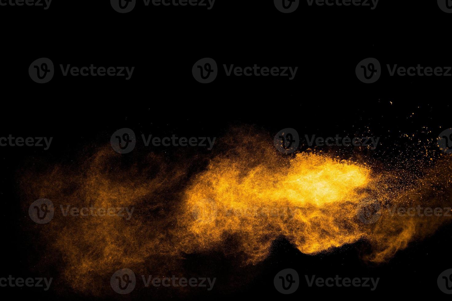 Freeze motion of yellow orange dust particles splash photo