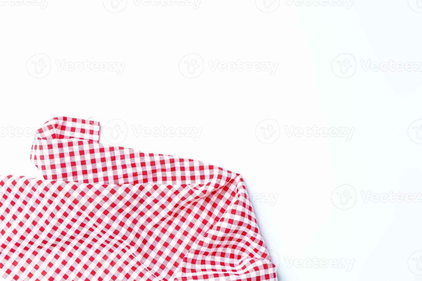 Red white checkered tablecloth isolated on white background top view. Fabric for a picnic on the holiday weekend. Backdrop, Design, Abstract. photo