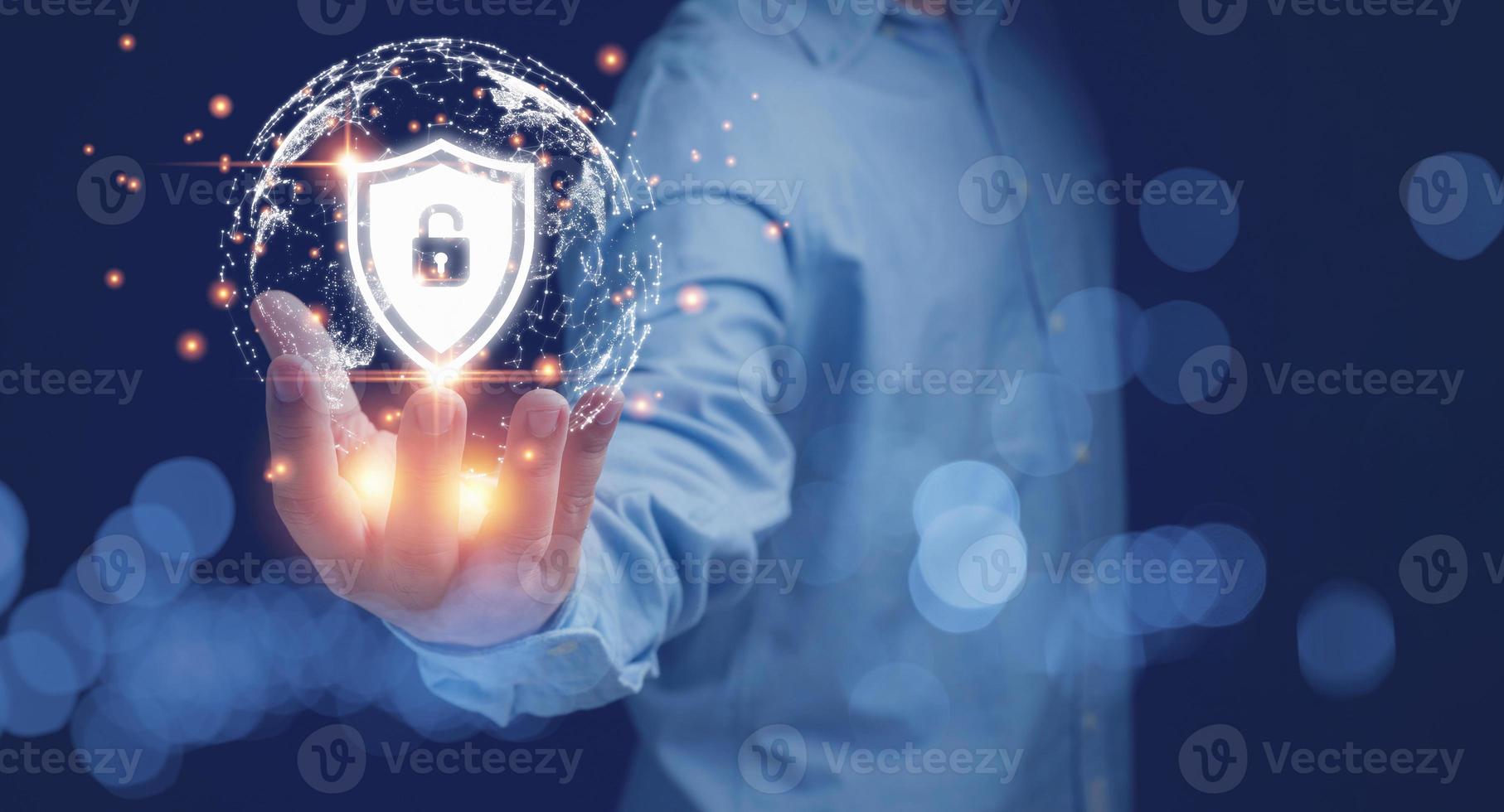 Businessman holding shield padlock with the virtual world on hand. Protecting data business, and personal information. Cyber security data concept. Padlock and internet technology. photo